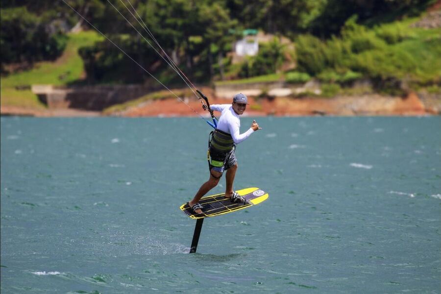 A kitesurfer riding a hydrofoil board